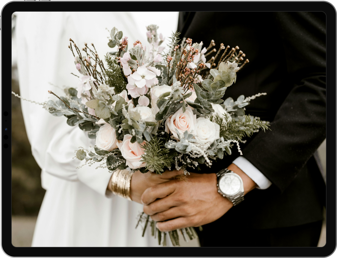 Image of a women holding some flowers on her weddings' day